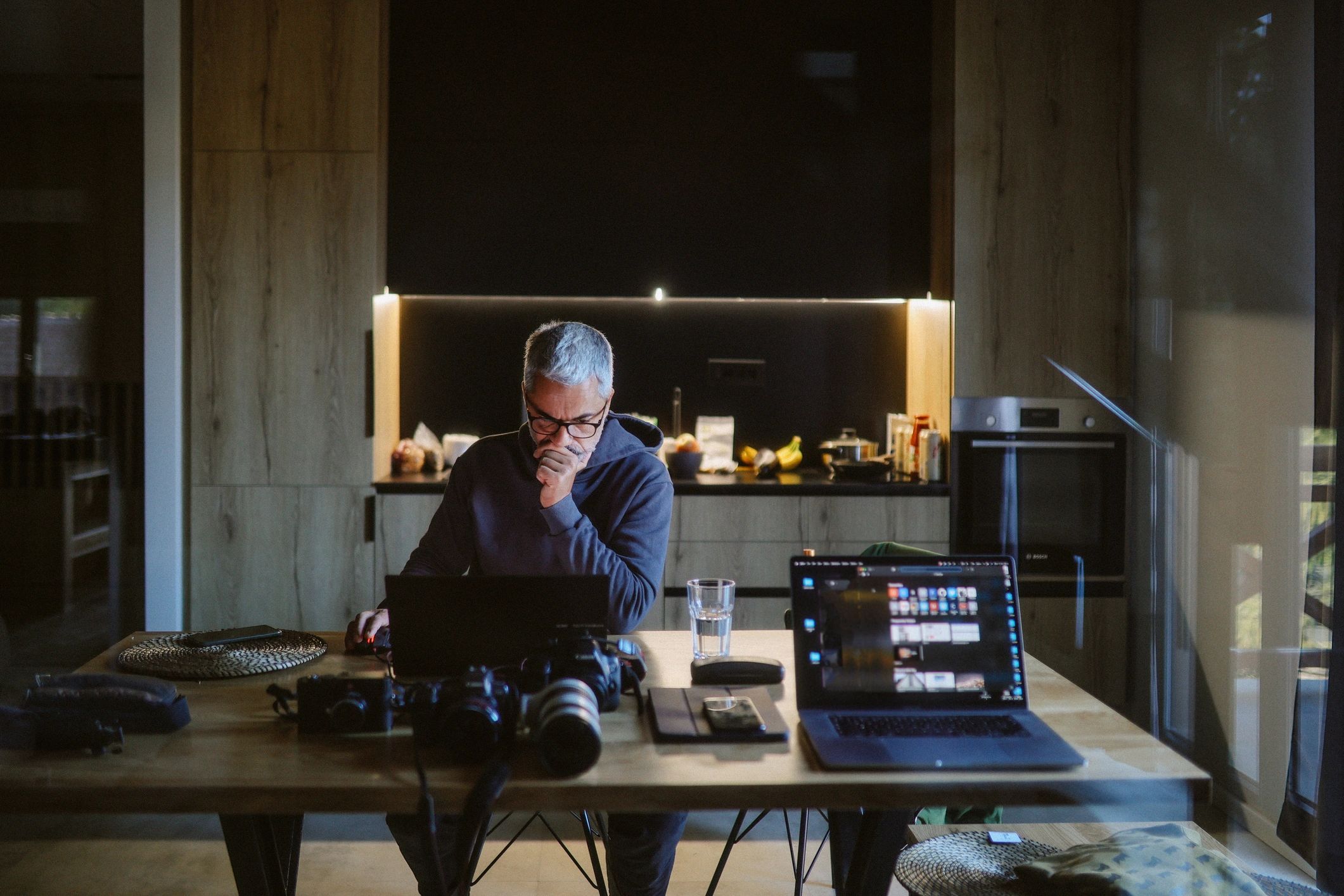 Person working on a laptop editing photos in a modern workspace