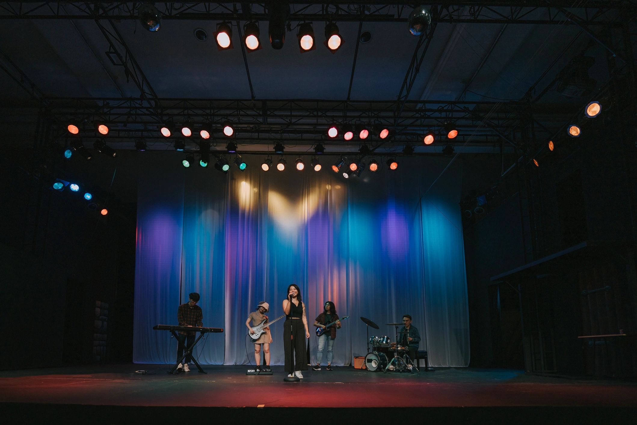 Live band performing on stage under concert lights