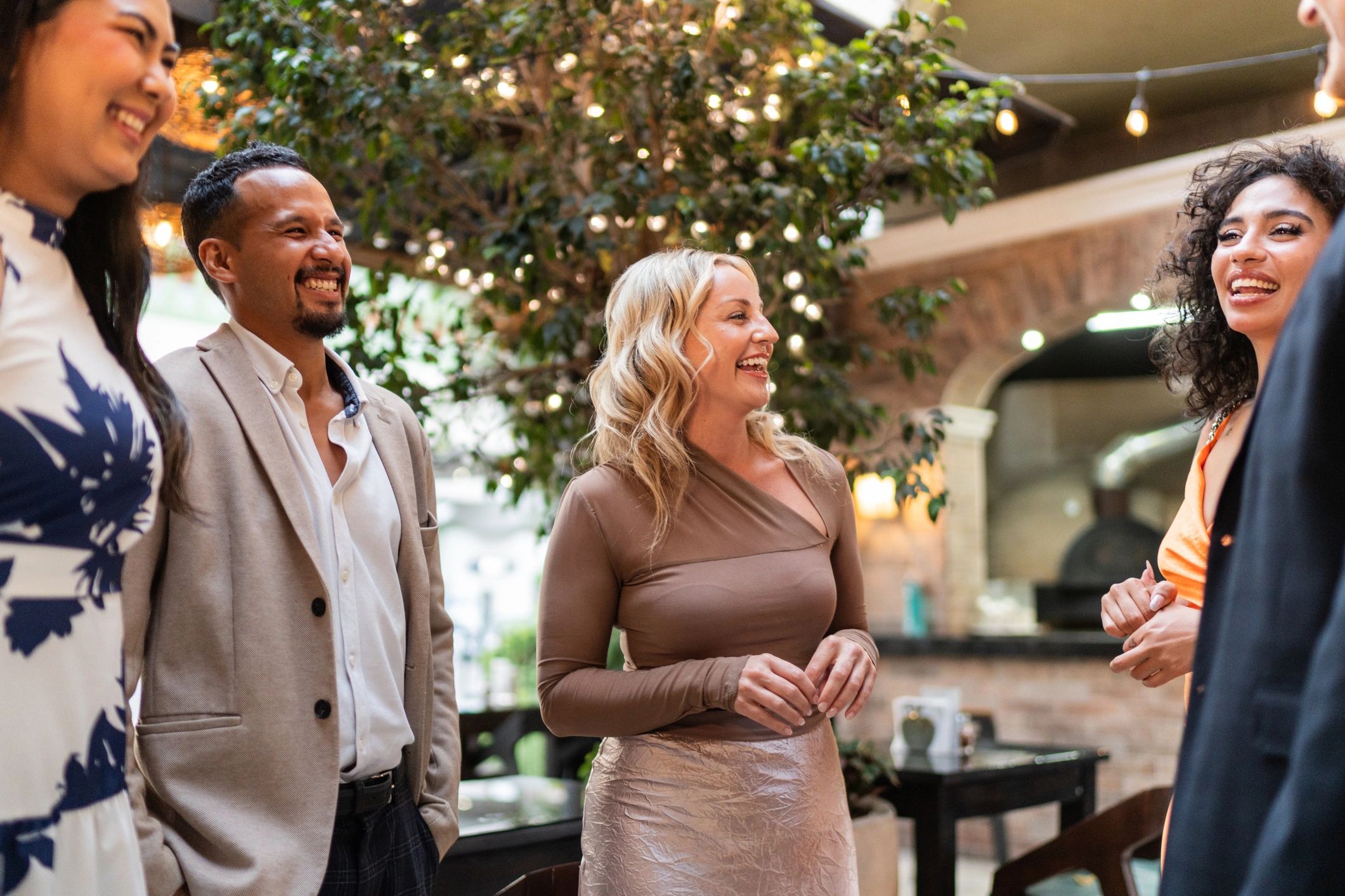 Friends talking outdoors at a reception-style gathering