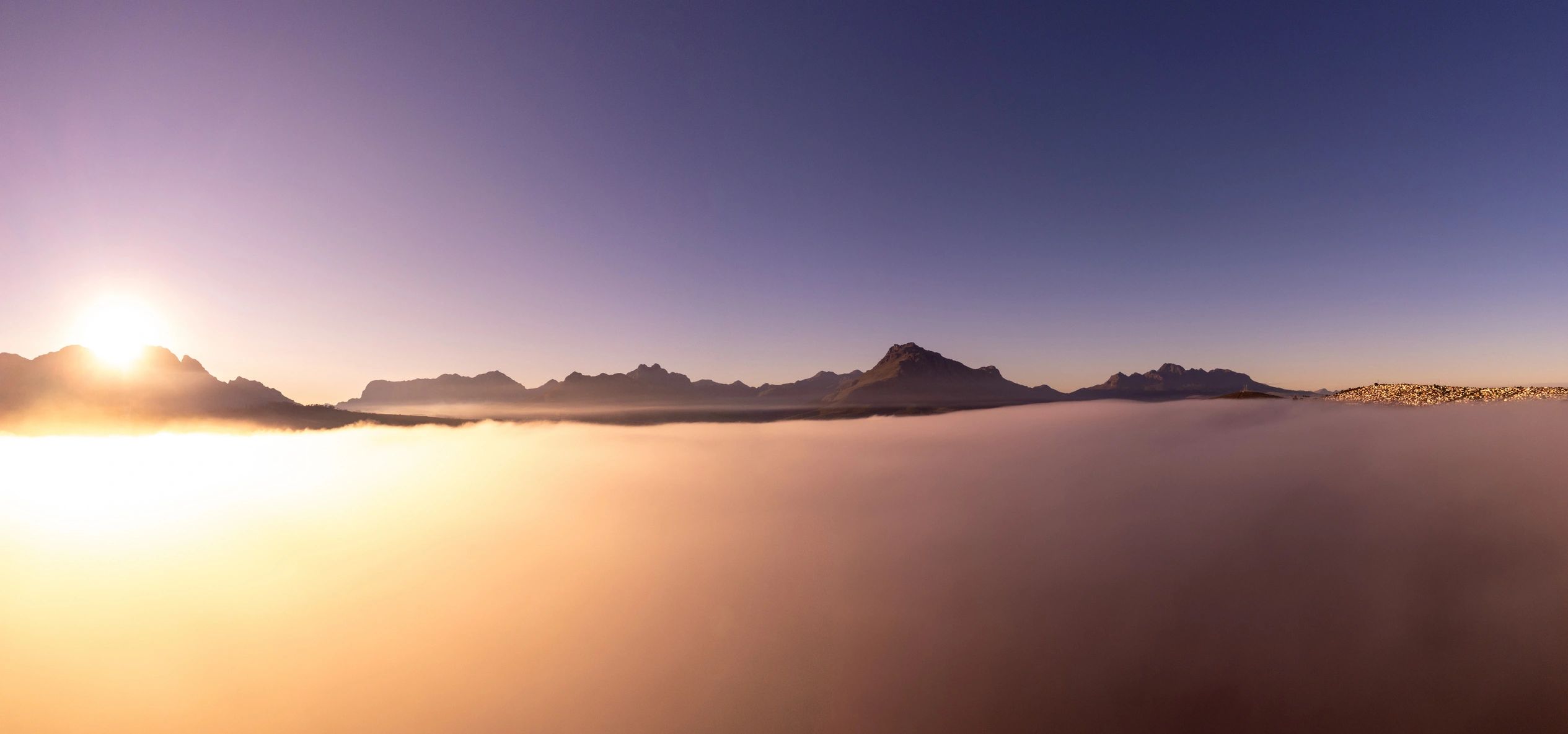 Aerial sunrise over foggy mountains
