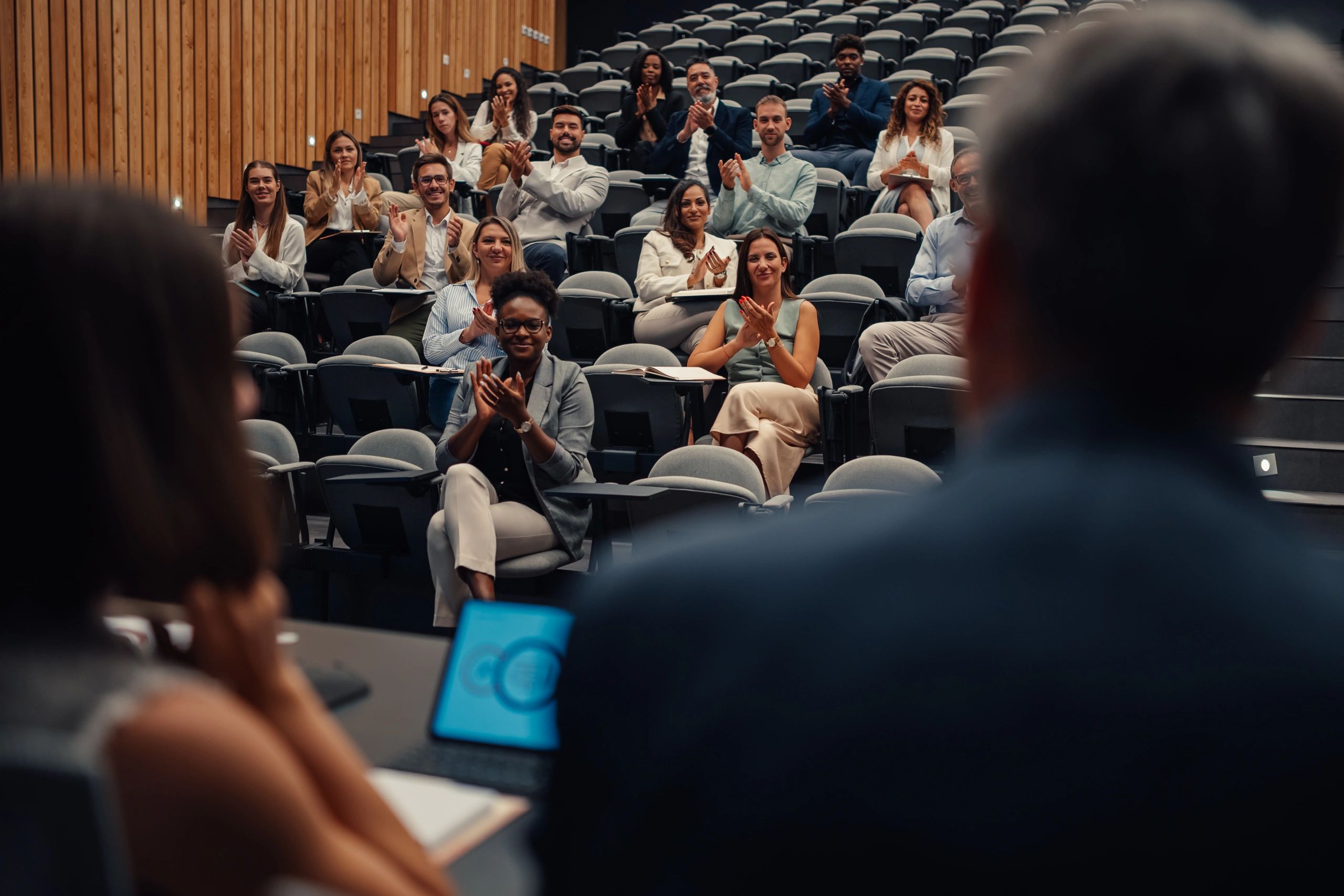 Conference audience applauding at a corporate event