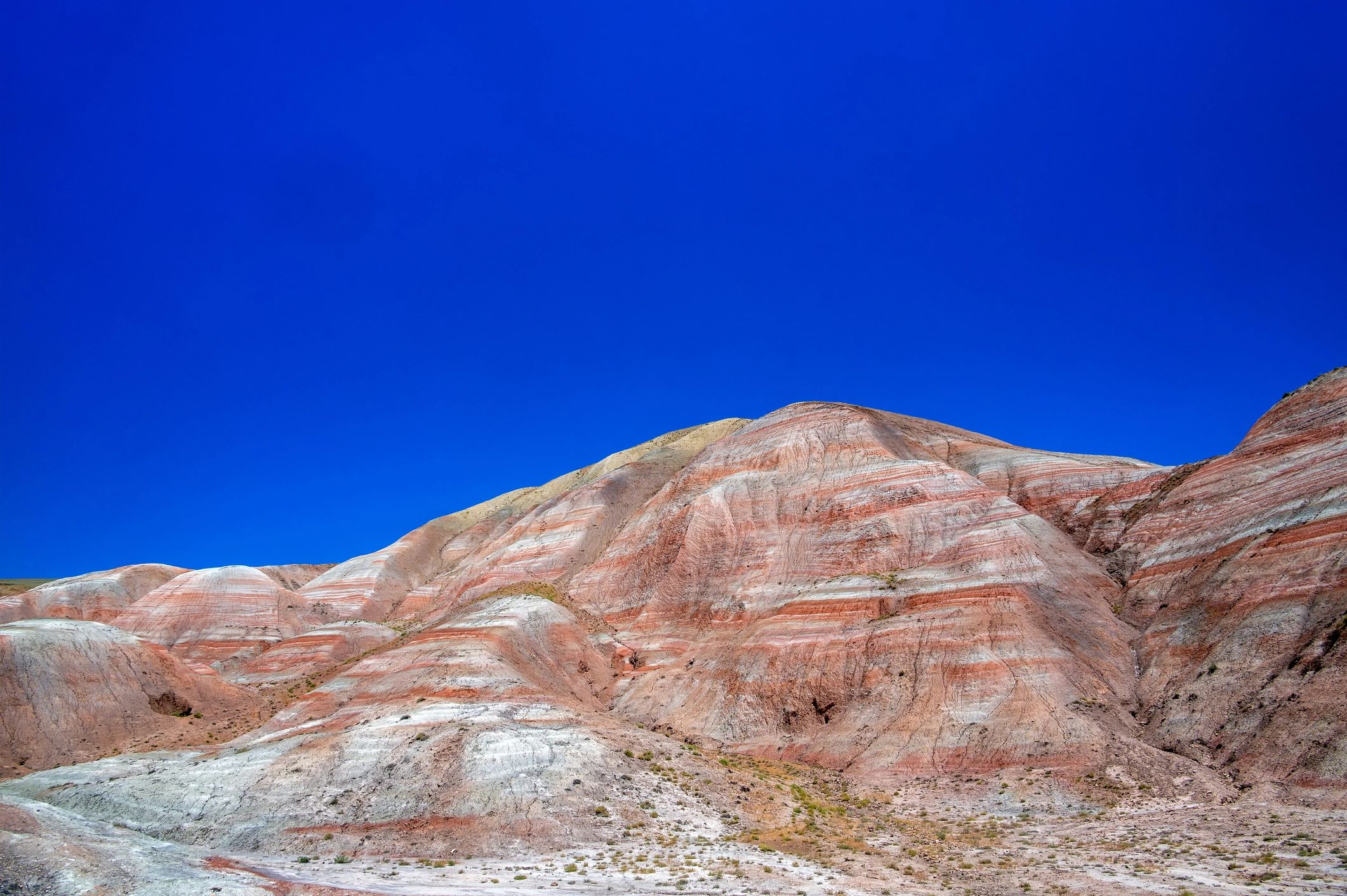 Striped candy cane mountains under blue sky